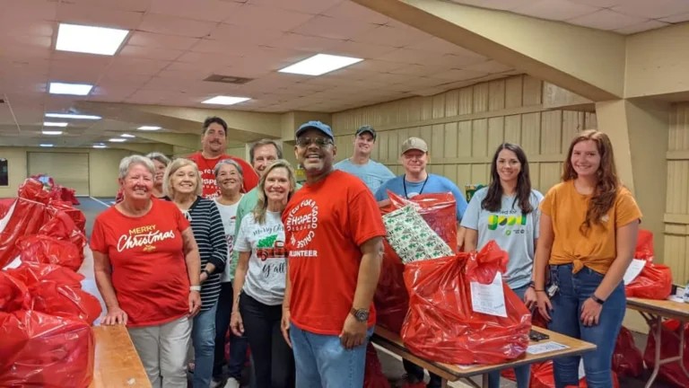 Volunteers with bags of gifts ready for families