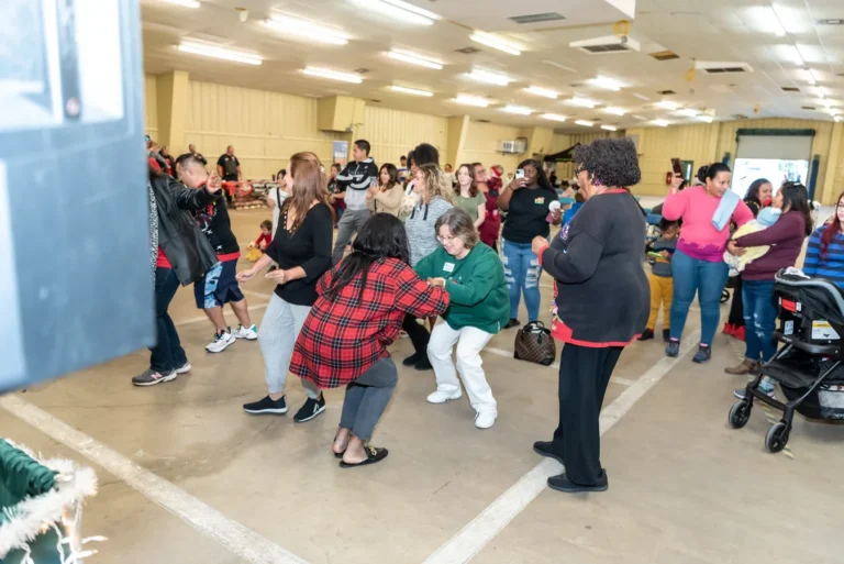 Families dancing at the Christmas Miracle Fiesta