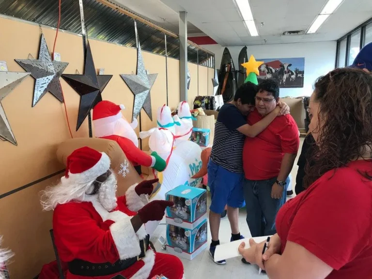 Santa visiting with a family during the Sleigh Ride