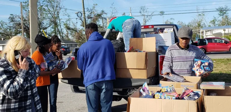 Volunteers unloading boxes of toys from a truck