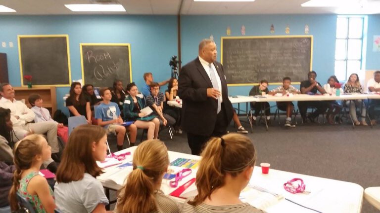 A speaker talking with students at a YOUth LEADership conference